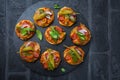 Homemade small pizza with pesto, salami, tomatoes and arugula Royalty Free Stock Photo