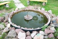 Homemade small stone pond fountain made of cobblestones Royalty Free Stock Photo