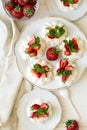 Homemade small strawberry pavlova meringue cakes with mascarpone cream and fresh mint leaves