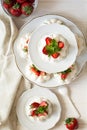 Homemade small strawberry pavlova meringue cakes with mascarpone cream and fresh mint leaves Royalty Free Stock Photo