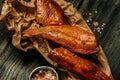 Homemade smoked river bass fish on wooden cutting board. Food recipe background. Close up