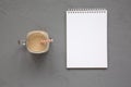 Homemade smoothie with coffee, oat and banana in a glass jar mug, blank notepad on a gray surface, top view. Overhead, from above Royalty Free Stock Photo