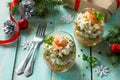 Homemade snacks on a festive Christmas table. Salad with shrimps, crab sticks, egg and corn