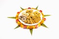 Homemade snacks with flowers kept with rangoli Royalty Free Stock Photo