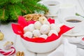 Homemade snowballs cookies with walnuts in icing sugar in a bowl on a white wooden background. Royalty Free Stock Photo