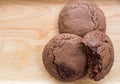 Homemade soft dark chocolate brownie cookies placed on a wooden plate. Close Up cookies are bitten. Look good and delicious