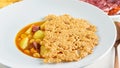 Fresh hot soup sauce of soybeans, potatoes and cheese chips above in the white bowl closeup. Healthy mediterranean food Royalty Free Stock Photo