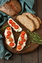 Homemade sourdough bread with cream cheese and cherry tomatoes Royalty Free Stock Photo