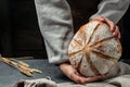 Homemade sourdough bread in hands. Craft authentic bread. Home cooking. Food preparation. Culinary, cooking, bakery concept