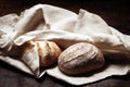 Homemade sourdough bread on linen towel on rustic table
