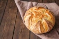 Homemade sourdough bread in a wooden tray on a wooden background Royalty Free Stock Photo