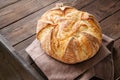 Homemade sourdough bread in a wooden tray on a wooden background Royalty Free Stock Photo