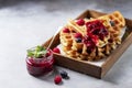 Homemade sourdough waffles with berry sauce for breakfast. The concept of proper nutrition