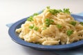 Homemade spaetzle with parsley garnish on a blue plate and a white table, typical dish in Schwaben, southern Germany and Austria, Royalty Free Stock Photo