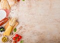 Homemade spaghetti pasta with quail eggs with bottle of tomato sauce and cheese on wooden background. Classic italian village food