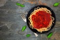 Spaghetti pasta with tomato sauce, peppers and mushrooms, above view over dark stone Royalty Free Stock Photo