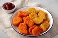 Homemade Spicy Chicken Nuggets Mix with Ketchup on a gray background, side view. Close-up Royalty Free Stock Photo