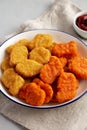 Homemade Spicy Chicken Nuggets Mix with Ketchup on a gray background, side view. Close-up Royalty Free Stock Photo