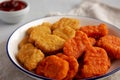 Homemade Spicy Chicken Nuggets Mix with Ketchup on a gray background, side view. Close-up Royalty Free Stock Photo