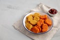 Homemade Spicy Chicken Nuggets Mix with Ketchup on a gray background, side view. Copy space Royalty Free Stock Photo