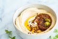 Homemade spicy hummus with tahini and olive oil in bowl, white marble background. Israeli traditional food Royalty Free Stock Photo