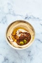 Homemade spicy hummus with tahini and olive oil in bowl, white marble background. Israeli traditional food Royalty Free Stock Photo