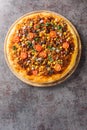 Homemade Spicy Mexican Taco PIzza with ground beef, tomatoes, corn, black beans, cheddar cheese, red onion on the wooden board. Royalty Free Stock Photo