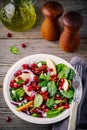 Homemade spinach, apple, pecan, red onion salad with goat cheese and pomegranate Royalty Free Stock Photo