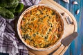 Homemade spinach french pie quiche lorraine on wooden board top view