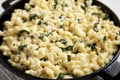 Homemade Spinach Mac and Cheese in a cast-iron pan on cloth, low angle view. Close-up Royalty Free Stock Photo