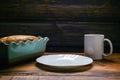 Homemade sponge cake in blue ceramic mold, white cup and white plate