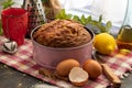 Homemade sponge cake and its ingredients, flour, eggs, sugar, olive oil, cinnamon and lemon