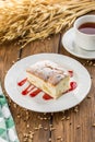 Homemade sponge cake with jam and cup of tea on wooden table Royalty Free Stock Photo