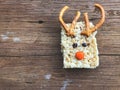 Homemade square bars of Rice Crispy Decorate Christmas reindeer on the wooden table Royalty Free Stock Photo