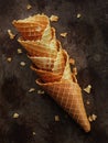Homemade stacked empty cornets or ice cream waffle cones on dark background