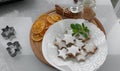 Homemade star-shaped cookies garnished with powdered sugar and a sprig of mint on a wooden tray Royalty Free Stock Photo