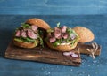 Homemade steak burger on wooden cutting board Royalty Free Stock Photo