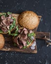 Homemade steak burger on wooden cutting board Royalty Free Stock Photo