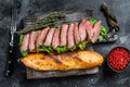 Homemade Steak sandwich with sliced roast beef, arugula and cheese. Black background. Top view Royalty Free Stock Photo