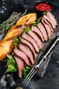 Homemade Steak sandwich with sliced roast beef, arugula and cheese. Black background. Top view Royalty Free Stock Photo