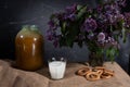 Homemade still life with flowers, milk and cookies. Milk and honey. Rural still life in a low key