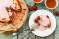 Homemade strawberry cake in baking paper with cream glaze served Royalty Free Stock Photo