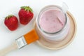 Homemade strawberry and greek yogurt face mask in a glass jar. Diy cosmetics. Top view, copy space. Royalty Free Stock Photo