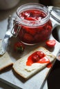 Homemade strawberry jam in a jar, fresh strawberries, bread and butter sandwich on table Royalty Free Stock Photo
