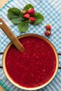 Homemade strawberry jam (marmelade) cooking. Large pot with hot jam and fresh strawberries Royalty Free Stock Photo