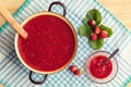 Homemade strawberry jam (marmelade) cooking. Large pot with hot jam and fresh strawberries Royalty Free Stock Photo