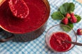 Homemade strawberry jam (marmelade) cooking. Large pot with hot jam and fresh strawberries Royalty Free Stock Photo