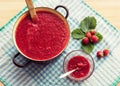 Homemade strawberry jam (marmelade) cooking. Large pot with hot jam and fresh strawberries Royalty Free Stock Photo