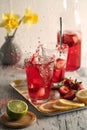 Homemade strawberry lemonade and slashing ice cubes Royalty Free Stock Photo