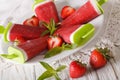 Homemade strawberry popsicle on a stick close-up. horizontal Royalty Free Stock Photo